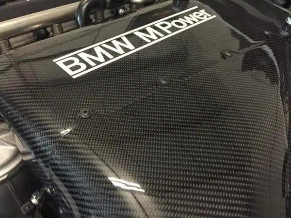 Close-up of a carbon fiber BMW M Power engine cover.