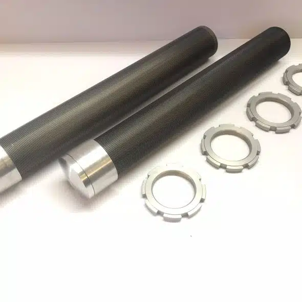 Two black metal rods with silver ends, next to five round metal washers on a white surface.