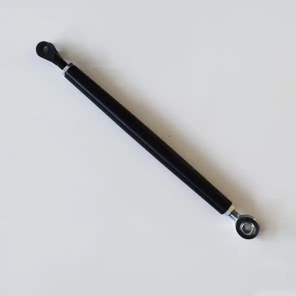 Black metal compression strut with mounting holes on each end, placed on a white background.