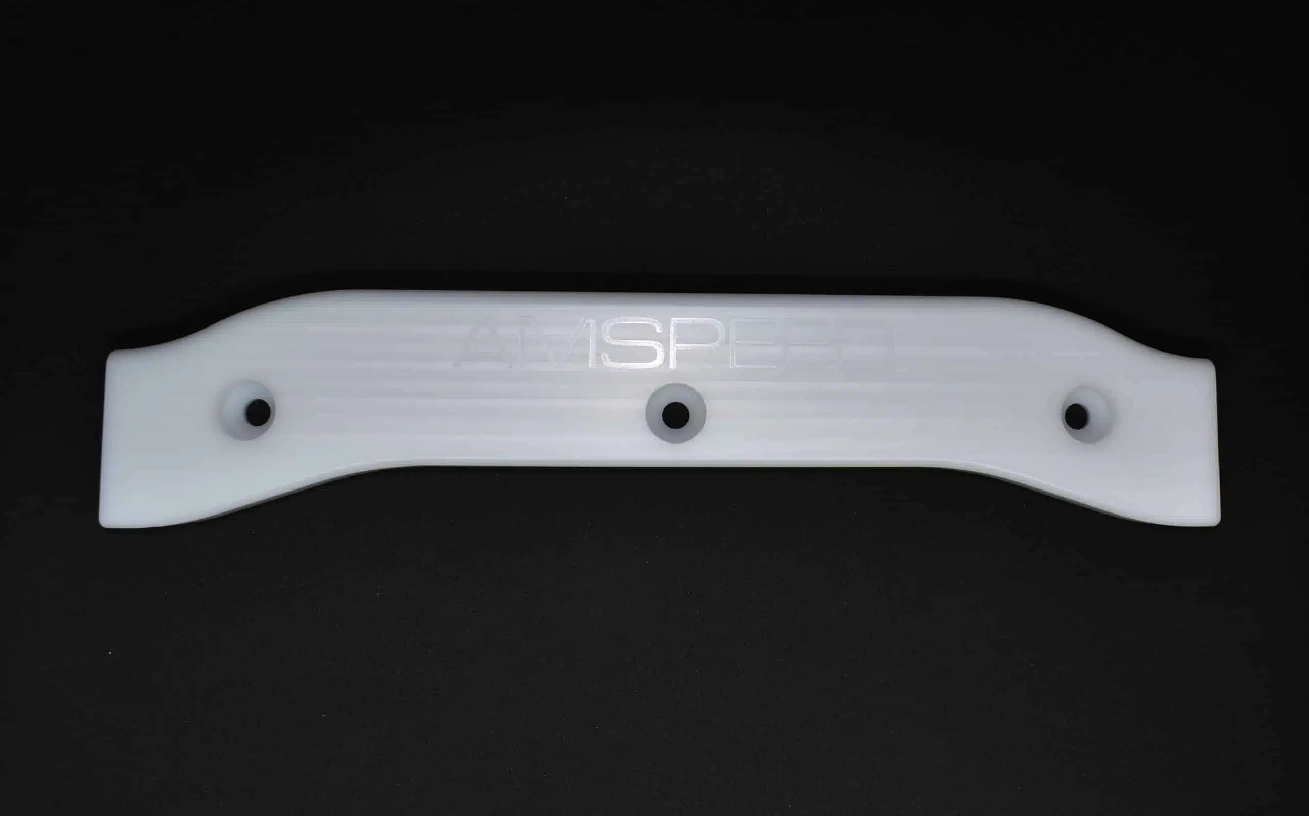 White plastic bracket with three holes, displayed on a black background.