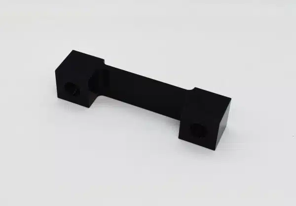 Black rectangular metal bracket with two square ends on a plain white background.