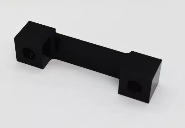 Black rectangular metal bracket with holes at each end, shown on a white background.