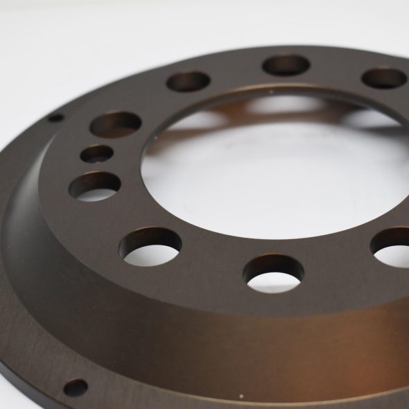 A metal circular flange with multiple holes on a white background.