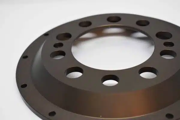 A metal circular flange with multiple holes on a white background.