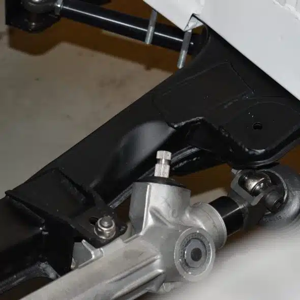 Close-up of a metal car suspension and steering component.