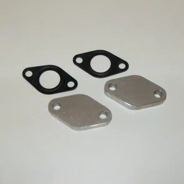 Two metal blanking plates and two black gaskets on a plain white background.