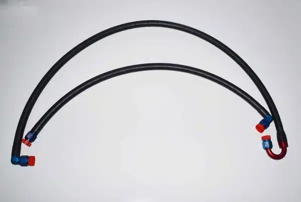 Two black engine oil cooler hoses with colored metal fittings on a white background.
