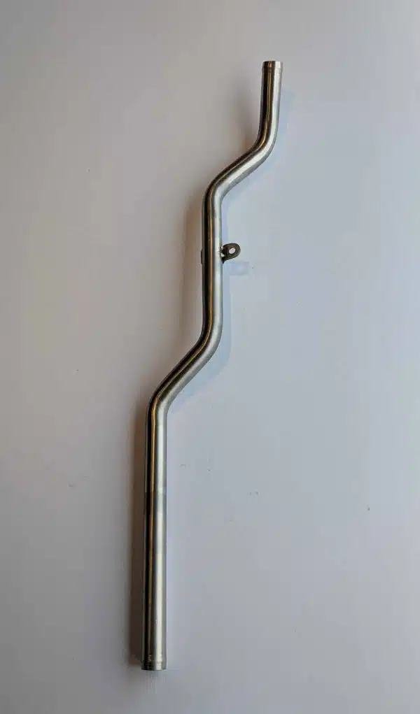 A metal bar with angled bends and a small protruding peg, placed on a white surface.