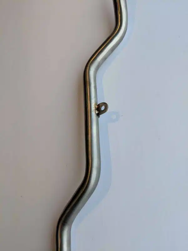 Curved metal bar with a knob in the center, placed on a plain white background.