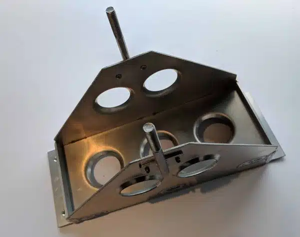 A metal frame with circular cutouts and two vertical rods on a white background.