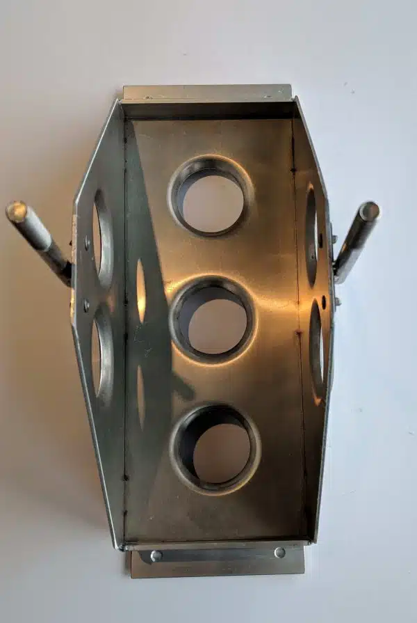 Metallic object with circular holes and two handles on each side, viewed from above on a white background.