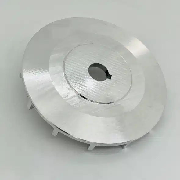 Round metal component with a central hole, placed on a plain white background.