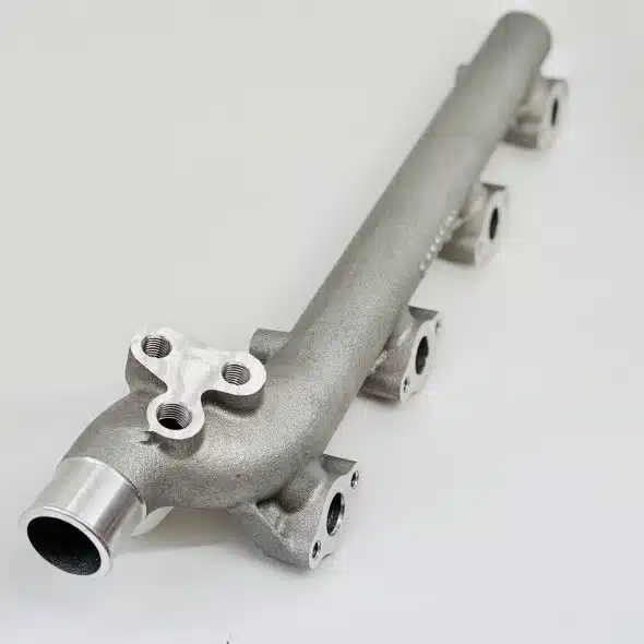 Metal automotive or industrial pipe component with multiple mounting points on a white background.